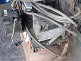 a large air compressor sitting on a cart in a garage