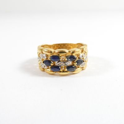 a close up of a gold ring with sapphires and diamonds