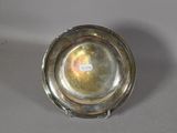 a silver plate on a table with a label on it