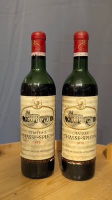 deux bouteilles de vin posées sur une table l'une à côté de l'autre