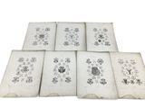 six old books with drawings of birds and flowers on them
