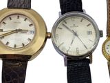 three different types of watches are displayed on a white surface