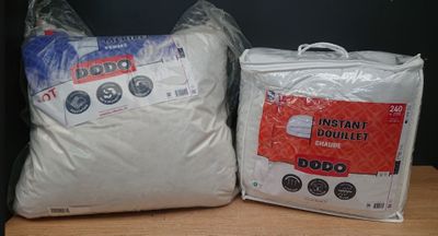 deux sacs contenant des oreillers blancs posés sur une table en bois