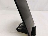 a tablet computer sitting on a stand on a table