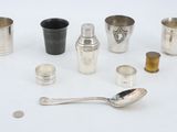 many different types of silverware on a white surface