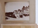 three old photos of a group of people hanging on a wall