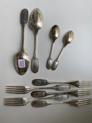 several spoons, forks, and spoons are arranged on a table