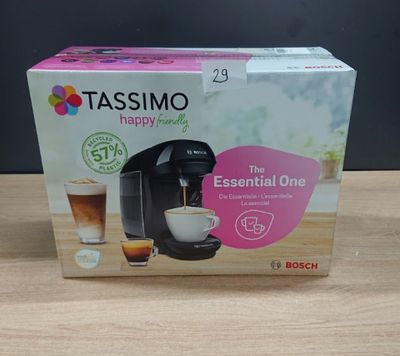 a box of tassimo coffee machine sitting on top of a wooden table