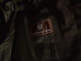 the back of a black jacket with a brown label on it