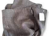 grey wool pants with a white label on the pocket