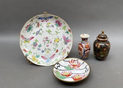 a plate, bowl, and vase sitting on a table