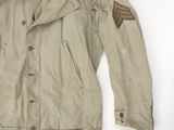 an old military jacket with patches on the sleeves and shoulder