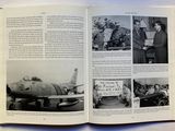 an open book with pictures of people and a plane in it