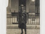 an old photo of a man standing on the sidewalk