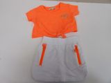 an orange shirt and white skirt with orange zippers on a table