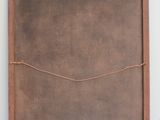 an old wooden frame with a string wrapped around it on a shelf