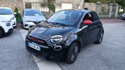 une petite voiture noire garée sur le bord de la route