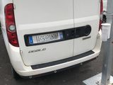 a white van parked next to a parking meter in a parking lot