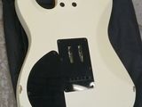an electric guitar sitting on top of a black bag on the ground