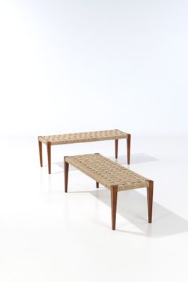 two wooden benches sitting next to each other on a white surface