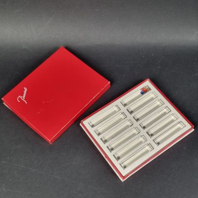 a red box that has a set of six pairs of scissors in it