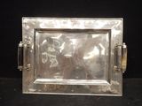 a silver tray with a picture in it on a black surface