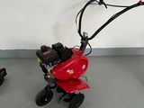 two small lawn mowers that are sitting on the floor
