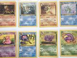 the pokemon cards are lined up on a white surface