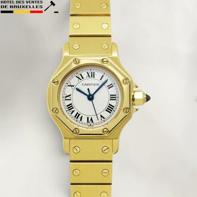 an image of a gold wrist watch with roman numerals and a white dial