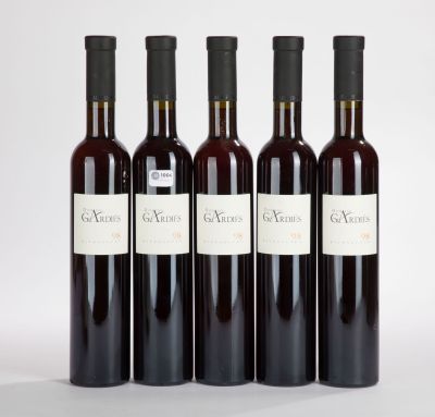 three bottles of wine sitting next to each other on a white surface