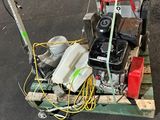a small machine that is sitting on a pallet in the street