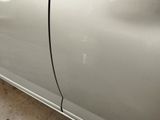 a picture of a car with a denting dent on the side of it