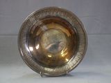 a silver plate with a picture of a man on it