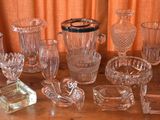a lot of glass items sitting on a wooden table