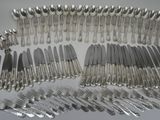 many forks and spoons laid out on the table