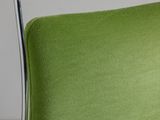 the back of a green chair with a chrome frame on a white table