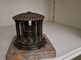 a small statue of a building on a shelf