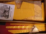 packaging of a box containing a pair of yellow gloves and a pair of red and yellow gloves
