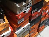 boxes of shoes are stacked on top of each other in a store