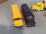 several toy trucks are lined up on a table next to a cardboard box