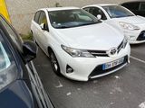 cars parked in a parking lot next to a building with a yellow sign