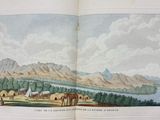 an open book with a picture of a mountain and a river
