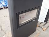 a black stove sitting on top of a pallet in a warehouse