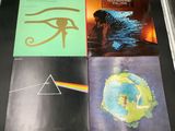 three pink floyd albums on a table with a pyramid and eye of horus