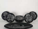 a black and white plate with a fish design on it
