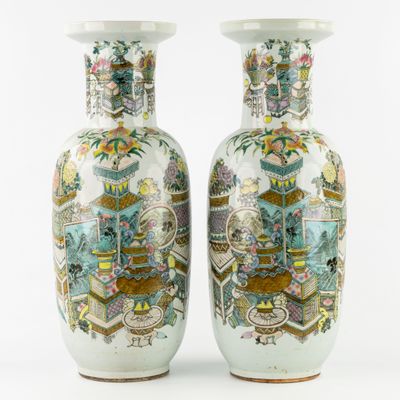 pair of chinese vases decorated with images of people and flowers
