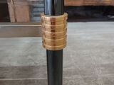 a close up of a metal pole with a gold band around it
