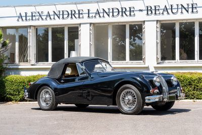 a black sports car parked in front of a building