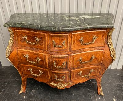 a marble top chest of drawers with a marble top