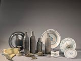 many different types of vases and plates on the table